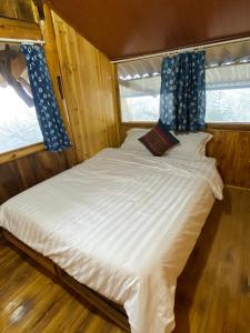 a large white bed in a room with a window at Friendly Homestay & Authentic Trekking Tours in Sapa +15 photos