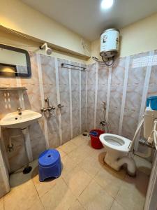 a bathroom with a toilet and a sink at hotel sagnik in Murshidābād +38 photos
