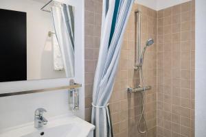 a bathroom with a shower and a sink at Dancenter Hotel Jomfru Ane in Aalborg +39 photos