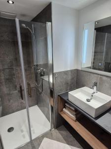a bathroom with a sink and a shower at Reiterhof in Westendorf +32 photos
