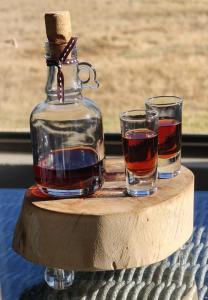 a bottle of whiskey and two glasses on a table at Springwater Cottages in Ficksburg +47 photos