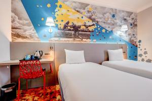 a hotel room with two beds and a desk at Manchester Portland By Sunday in Manchester