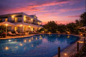 a large swimming pool in front of a house at Villa Riviera in Stavros