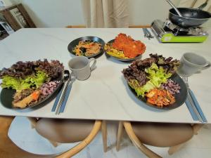 a table with four plates of food on it at Dodahm guesthouse stay in Incheon