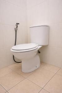 a bathroom with a white toilet in a room at Hotel Danau Indah By ARBA in Cibuntu