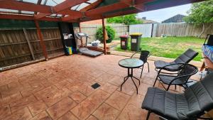 a patio with chairs and a table and a grill at Private Room with a view, close to everything in Sydenham