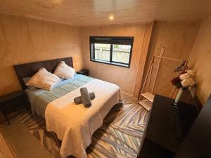 a bedroom with a bed in a room with a window at The Mango Shed in Mangakino +20 photos