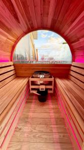 a small room with a window in a wooden room at The Mango Shed in Mangakino