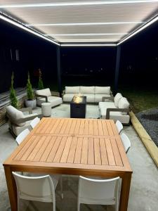 a wooden table and chairs in a living room at The Mango Shed in Mangakino