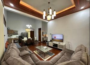 a living room with a couch and a tv at Puri Sagan in Yogyakarta