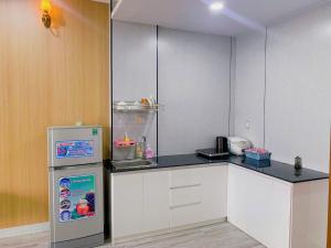 a kitchen with a refrigerator and a counter top at HomeDubai in Kinh Dinh +15 photos