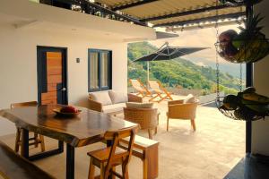 a living room with a table and chairs at Casa Margarita Loft in Buenavista