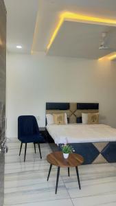 a bedroom with a bed and a table and a chair at Hill Touch Villa in Thūr
