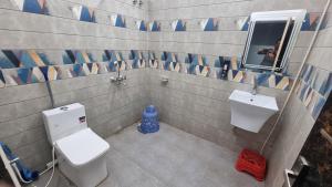 a bathroom with a toilet and a sink at Hotel Vijay Greens in Orchha