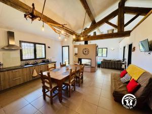 a kitchen and living room with a table and a couch at Nore & nature in Pradelles-Cabardès +18 photos