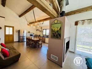 a large living room with a table and a kitchen at Nore & nature in Pradelles-Cabardès