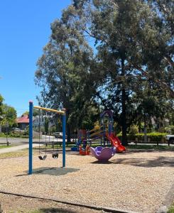a park with a playground with a slide at Your Leafy Ivanhoe Retreat in Melbourne