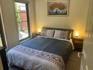 a bedroom with a bed and a window at Your Leafy Ivanhoe Retreat in Melbourne