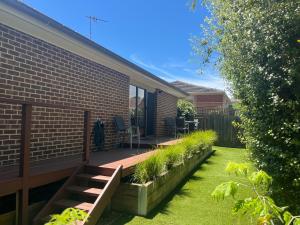 a patio with a bench and plants on a house at Your Leafy Ivanhoe Retreat in Melbourne
