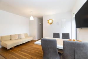 a living room with a couch and a table at Apartments Rialto in Veli Lošinj