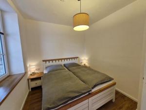 a bedroom with a large bed and a lamp at Ferien im Denkmal in Sundern