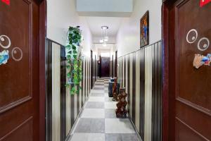 a hallway with wooden doors and a tile floor at Hotel O Govind Guest house in Jhājra