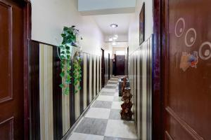 a hallway with a plant on the wall at Hotel O Govind Guest house in Jhājra