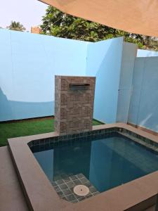 a swimming pool with a fireplace in a house at Sea Shades Cottages I Private Jacuzzi in Palolem