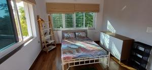 a small room with a bed and a window at 'Tatvamasi' Farmstay, Hillock The Nature Retreat, Vikarabad in Morangpalli +16 photos