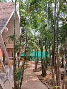 a view of the beach from a resort with palm trees at Sea Shades Cottages I Private Jacuzzi in Palolem