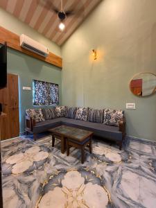 a living room with a couch and a table at Magic holiday home in Matheran +21 photos