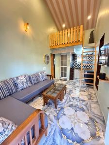 a living room with a couch and a table at Magic holiday home in Matheran