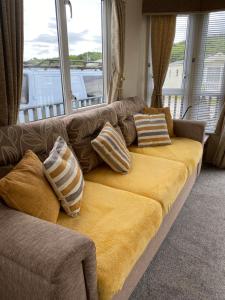 a couch with pillows on it in a living room at The Highlander in Tain