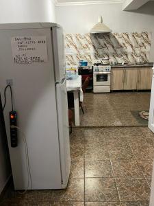 a kitchen with a refrigerator with a sign on it at Anissa in Shymkent