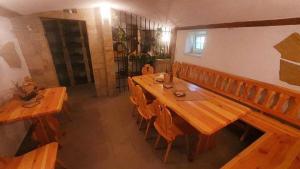 a room with a long wooden table and chairs at Penzion rodina in Chornice +13 photos