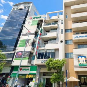 a building in a city with people walking in front of it at Duy Khang 1 Hotel in Ho Chi Minh City
