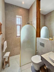 a bathroom with a toilet and a sink at Halisi Villas in Nungwi +18 photos