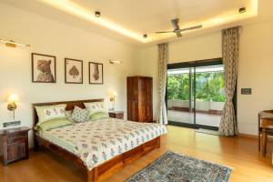 a bedroom with a bed and a large window at Moti Villa in Jāmb