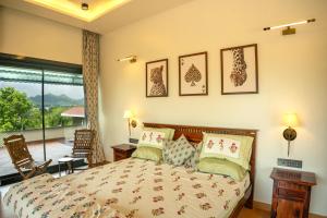 a bedroom with a bed and a balcony at Moti Villa in Jāmb +6 photos