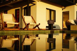 two chairs sitting next to a swimming pool at Casa Margarita Loft in Buenavista