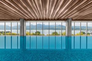 a swimming pool with a view of the water at The Westin Yichang in Yichang