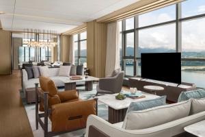 a living room with couches and a flat screen tv at The Westin Yichang in Yichang