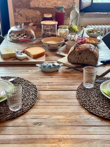 a wooden table topped with plates and bowls of food at Casale le Fontanelle in Monte Grimano Terme
