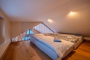 two beds in a room with a staircase at Rekreačné domy Marina Cabin House in Bobrovník +32 photos