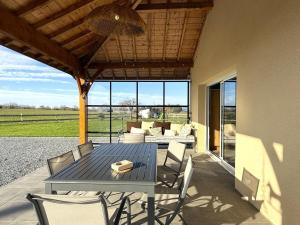 a patio with a table and chairs and a couch at Prat in Livron