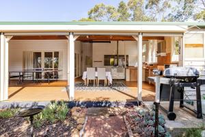 an open deck with a grill and a kitchen at Bonnie Brae Retreat in Swansea