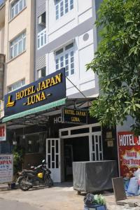 a hotel japan inn with a motorcycle parked in front of it at Japan Luna Hotel in Dĩ An
