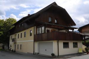 a house with a gambrel roof and a garage at Gästehaus Brugger in Hermagor