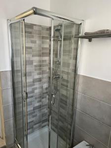 a shower with a glass door in a bathroom at SantegidioHomeCesena in Cesena