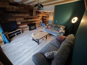 a living room with a couch and a table at L'orée du lac in Kruth